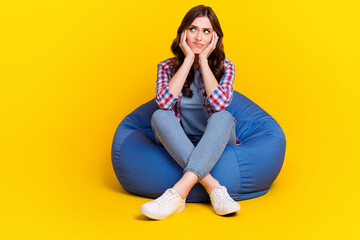 Poster - Photo of pretty nice girl wavy hairdo dressed checkered shirt arms on cheekbones look empty space isolated on yellow color background