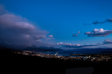 Poster - Evening look at the city of Ushuaia,  between the Andres mountains and saltwater Harbor. 