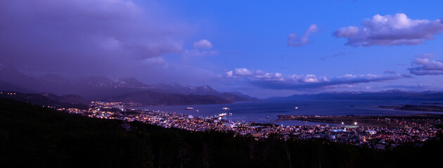 Poster - Evening look at the city of Ushuaia,  between the Andres mountains and saltwater Harbor. 