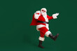 © deagreez - Full body profile side photo of santa claus with big belly beard carry x-mas present gift sack go wear headwear cap sunglass isolated over bright shine color background