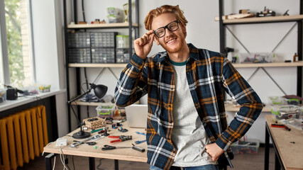 IT engineer with hand on hip looking at camera
