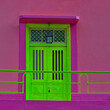 Green Door . Pink wall in background. Stock Image.