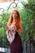 © pliekhova - Portrait of lovely slim redhead girl in wine dress and dreamcatcher craft talisman