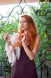 © pliekhova - Portrait of lovely slim redhead girl in wine dress and dreamcatcher craft talisman