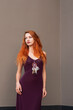 © pliekhova - Portrait of lovely slim redhead girl in wine dress and dreamcatcher craft talisman