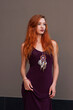 © pliekhova - Portrait of lovely slim redhead girl in wine dress and dreamcatcher craft talisman