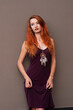 © pliekhova - Portrait of lovely slim redhead girl in wine dress and dreamcatcher craft talisman