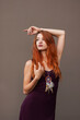 © pliekhova - Portrait of lovely slim redhead girl in wine dress and dreamcatcher craft talisman