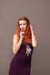 © pliekhova - Portrait of lovely slim redhead girl in wine dress and dreamcatcher craft talisman