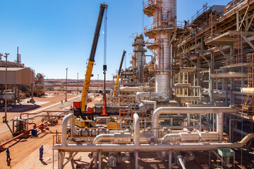 Oil refinery plant with bundle pulling operation, landscape with blue sky 