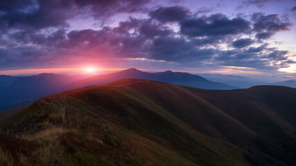 Wall Mural - Panoramic view of colorful sunrise in mountains. Concept of the awakening wildlife, romance, emotional experience in your soul, joy in mundane life. 