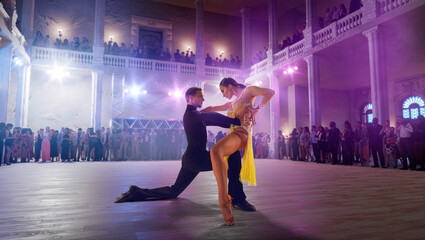 Wall Mural - Couple dancers  perform latin dance on large professional stage. Ballroom dancing.