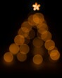 Dark view of a Christmas tree with bokeh lights