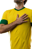 Fototapeta Sport - Brazilian soccer player, listening to the national anthem with his hand on his chest