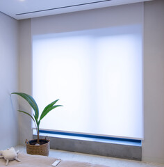 Leinwandbilder - Roller shade motorized in the interior. Automatic roller blinds white color on big window. Remote control shades are above a windowsill made from concrete. Remote control panel for blinds lies on bed.