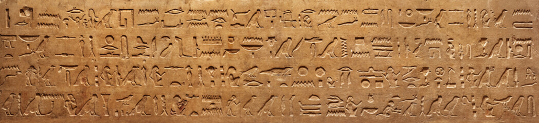 Old Egyptian hieroglyphs on an ancient background. Wide historical and culture background. Ancient Egyptian hieroglyphs as a symbol of the history of the Earth.