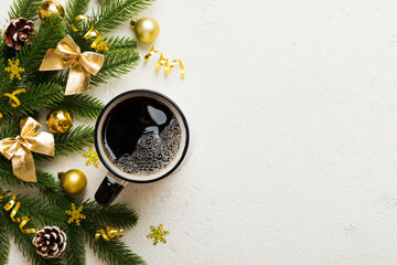 Delicious fresh festive morning coffee in a ceramic cup with little wrapped gifts, ornament and xmas toy. Cup of coffee and new year toys