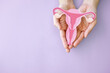 Hands holding uterus, female reproductive system , woman health, PCOS, gynecologist and cervical cancer concept
