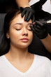 Beauty master applying permanent powder brow makeup