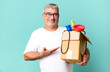 middle age senior man smiling cheerfully, feeling happy and showing a concept. housekeeper repairman with a toolbox concept
