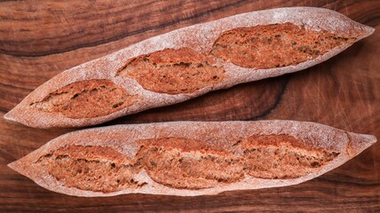 Top view of crunchy fresh bread on a wooden background