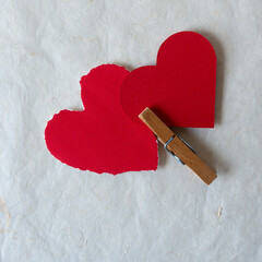 Poster - old clothespin and torn paper hearts on textured paper background