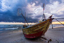A Wooden Fishing Boat On A Beach With A Stormy Shy Overhead At Mui Ne In Vietnam