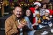 © Marcos - Hispanic senior man portrait holding a cup of fruit punch at traditional posada party for Christmas in Mexico Latin America
