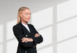 Attentive businesswoman wearing formal wear standing in cross ar