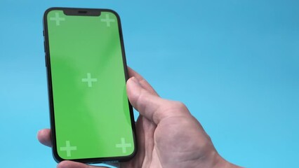 woman hand with smartphone with blank green screen, screen touch copy space for app or website desig