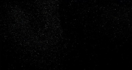 Wall Mural - Cinematic dust particles on black screen overlay. Filmed with RED camera in slow motion. Abstract shapes background. High quality 4k footage
