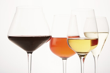 Pink, white, red, sparkling alcoholic drinks in wine glasses.