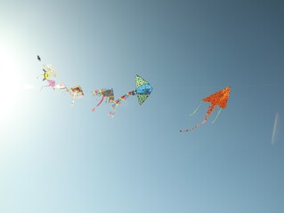 Wall Mural - Bright rainbow kites in blue sky, low angle view