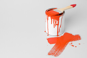 Wall Mural - Can of orange paint and brush on white background. Space for text