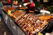 Delicious Grilled Seafood Octopus Tentacles Skewers. Traditional Food Stall In Japan. 