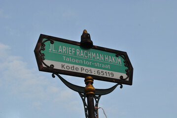 a street name in malang city with a vintage decorated signpost that means arief rachman hakim street