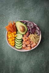 Wall Mural - Poke bowl with quinoa and salmon and raw vegetables, healthy food bowl, top view