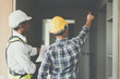 © itchaznong - Professional architect designer structural engineer team colleagues discussing building plan design project