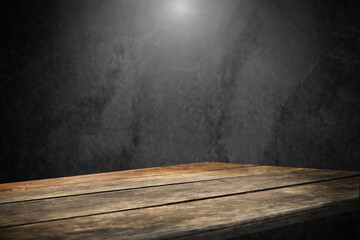 Poster - image of a wooden table on an abstract dark background with light in the center