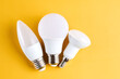 Different types of Light Bulbs isolated on yellow background