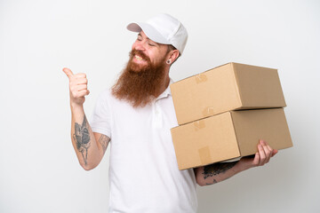 Wall Mural - Delivery reddish man isolated on white background pointing to the side to present a product