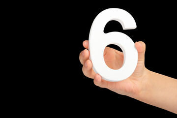 Aufkleber - Number six in hand isolated on black background. Number six in a child's hand holding on a black background. To be inserted into a project or design.