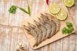 Fresh raw shrimp (Litopenaeus vannamei) on wooden plate.with copy space.Top view