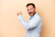 © luismolinero - Middle age caucasian man isolated on beige background doing strong gesture