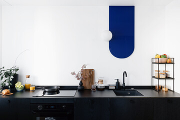 Wall Mural - modern interior in kitchen with black furniture and white wall