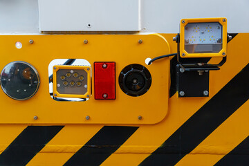 A big truck on the road. Modern new halogen headlights on a truck. Truck headlights.  Square red headlight and reflector on the back of the hood. Car detail, close-up.