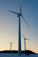 Wall Mural - low angle view of wind turbines against the sky at down