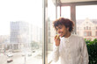 © jessica - Young man in the  office, eating an apple during a break in front of the window