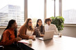 © jessica - Group of four young people , working in the office in front of a computer