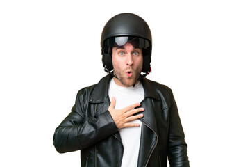 Wall Mural - Young caucasian man with a motorcycle helmet isolated on green chroma background surprised and shocked while looking right